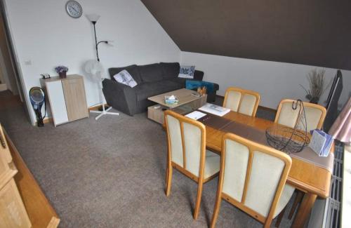 sala de estar con mesa y sofá en Haus Rehblick 2, Wg 3, en Sankt Andreasberg