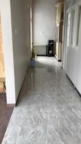 an empty hallway of a building with a tile floor at AAA, Surya Indah, Pananjakan Bromo Villa, Managed by Triple A Tour, Additional Bromo Sunrise Jeep Tour and Airport Shuttle in Pasuruan