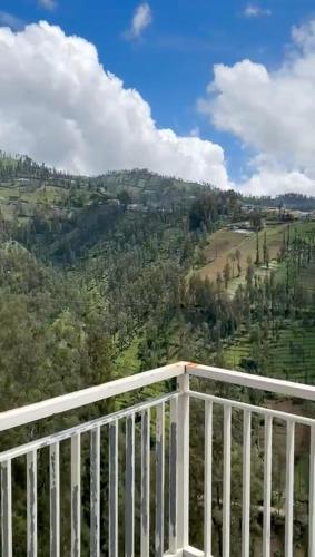a balcony with a view of a mountain at AAA, Surya Indah, Pananjakan Bromo Villa, Managed by Triple A Tour, Additional Bromo Sunrise Jeep Tour and Airport Shuttle in Pasuruan