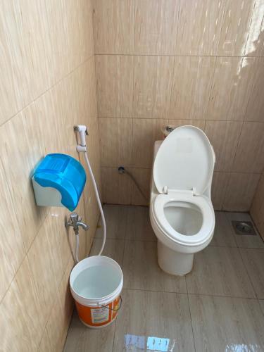 a small bathroom with a toilet in a stall at MKOLANI RAILWAY in Mwanza