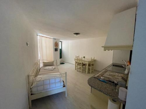 a small room with a bed and a table at La Casa nel Borgo in Ameglia