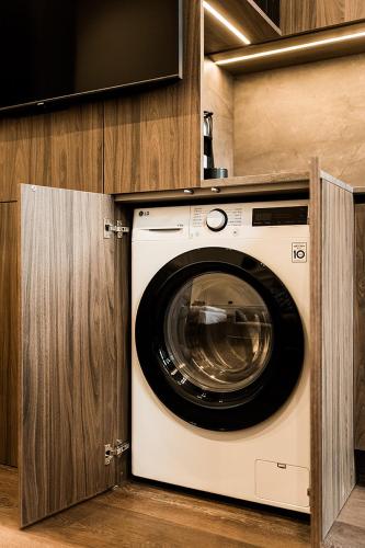 a washer and dryer in a kitchen at Central Park Apartments - The Luxury Collection in Kaunas