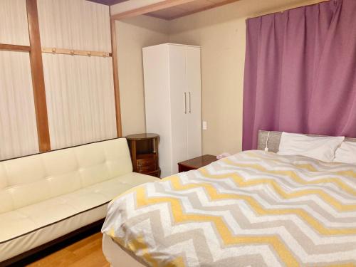 Postel nebo postele na pokoji v ubytování Guest House Izumi
