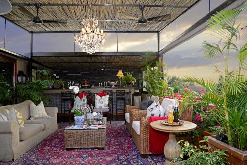 a living room with a couch and a table at The Residence in Johannesburg