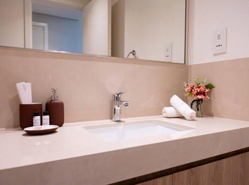 a bathroom counter with a sink and a mirror at WORLD CLASS 2BR with Downtown View in Dubai