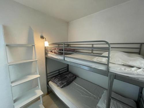 - une petite chambre avec des lits superposés et des étagères dans l'établissement Appartement 4 pers belle terrasse vue port, à Capbreton