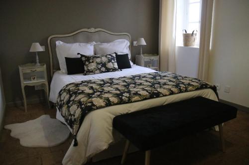 a bedroom with a large bed with pillows on it at Gite Le Cozy in Val-au-Perche