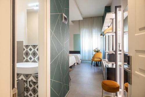 a small room with a bathroom with a bed and a sink at New Morpheus Rooms in Rome