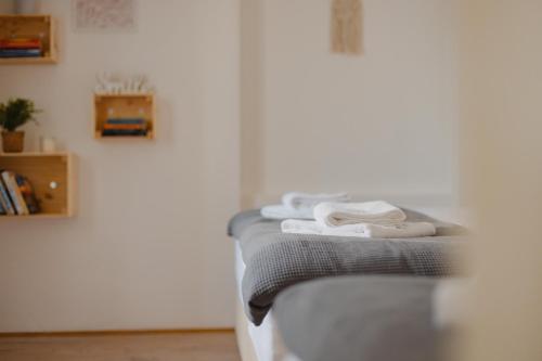 a group of towels sitting on a bed in a room at VILA KLARA apartments in Ljubljana