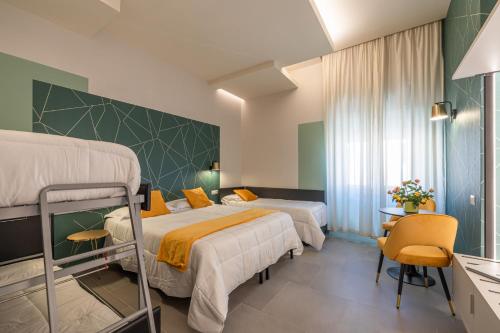 a hotel room with two beds and a desk at New Morpheus Rooms in Rome