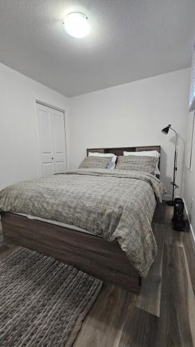 a bedroom with a large bed with two pillows at New Decently Furnished Suit in Regina