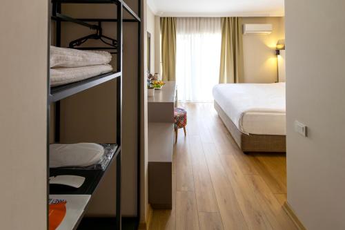 a hotel room with a bed and a bedroom at Mene City Hotel in Antalya