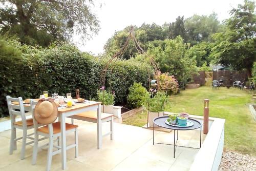 a table and chairs sitting on a patio at Quiet Devon Luxury Escape 3-Bed in Honiton