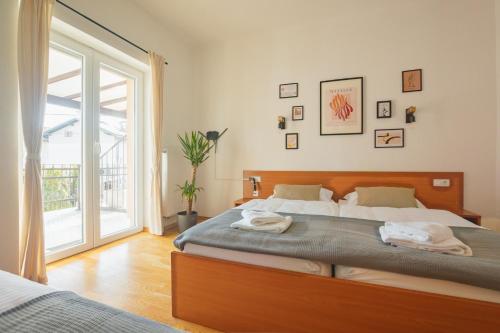a bedroom with a large bed with towels on it at VILA KLARA apartments in Ljubljana
