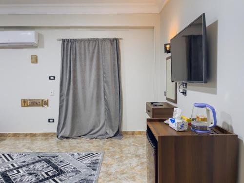 a hotel room with a tv and a room at Live pyramids in Cairo
