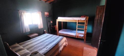 a room with two bunk beds and a window at La Martina. in Tunuyán