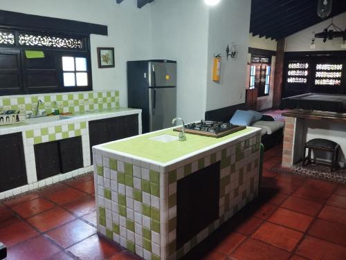 a kitchen with a island in the middle of a room at Finca el hato in Palmira