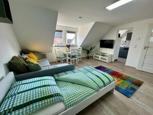 a bedroom with a bed and a living room at Ferienwohnungen GoJa in Bad Königshofen im Grabfeld