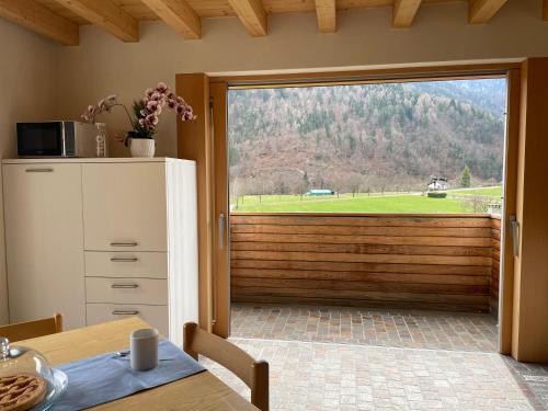 a kitchen with a sliding glass door with a view at Ledro Luxury Spa House in Ledro