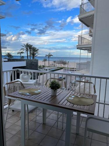 a table on a balcony with a view of the beach at Apartamentos Costa Blanca in Playa de Gandia