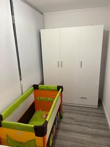 a childs room with a toy bed and white cabinets at Apartamentos Costa Blanca in Playa de Gandia