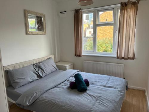 a bed with a pillow on it in a bedroom at Double Room near Canary Wharf 28 in London