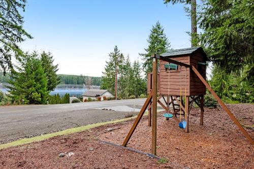a small playground with a house on the side of a road at Mason Magic Hideaway in Grapeview