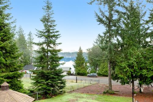 a view of a lake from a park with trees at Mason Magic Hideaway in Grapeview