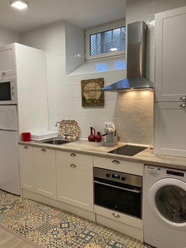 a kitchen with a washing machine and a washer at PLENO CENTRO COMILLLAS-3 Hab, 2 Baños in Comillas