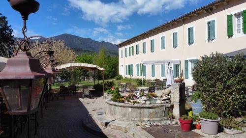 a courtyard with a fountain in front of a building at Hotel Carmel in Les Vans