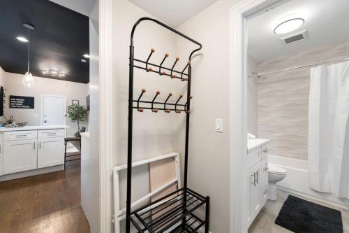a bathroom with a shower and a toilet and a sink at Stylish 2 BDR Coach House Steps From The Lake in Chicago