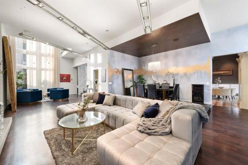 a living room with a couch and a table at 5BR 5BA Architectural Estate-Theatre Gym Rooftop in Chicago