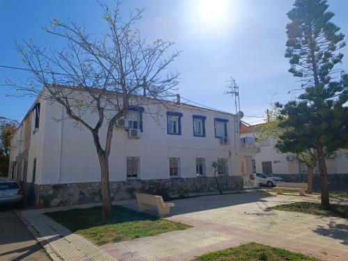a white building with a tree in front of it at Apartamento Caravaca in Santa Pola
