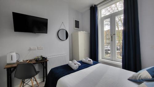 a bedroom with a bed with two stuffed animals on it at Argyle Square Hotel in London