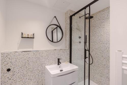 a bathroom with a sink and a shower at Frankie Says - London lodgings don't get more fabulous than the Fitz n' Glamour, a dazzling 1 BR apartment in central Fitzrovia in London
