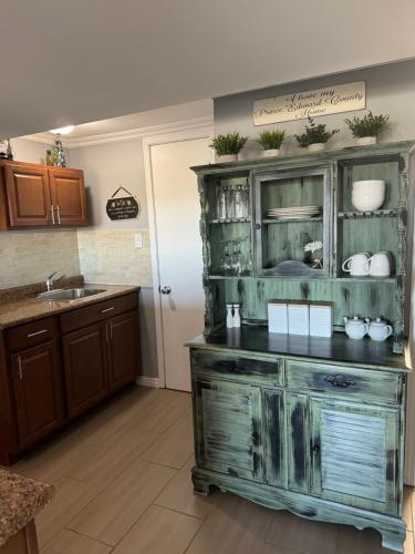 a kitchen with a large wooden hutch with plants on it at Lazy Dayz Vacation Rental in Picton