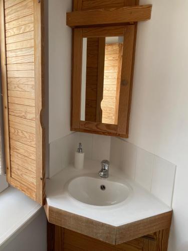 a bathroom with a sink and a mirror at Hôtel de La Plage - WISSANT in Wissant