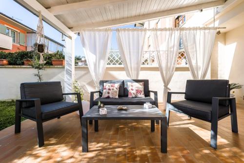 two chairs and a coffee table on a patio at Hostly - Giusy Garden Suite - Only for Holidays in Capannoli