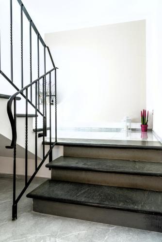 a set of stairs in a white room at Hostly - Giusy Garden Suite - Only for Holidays in Capannoli