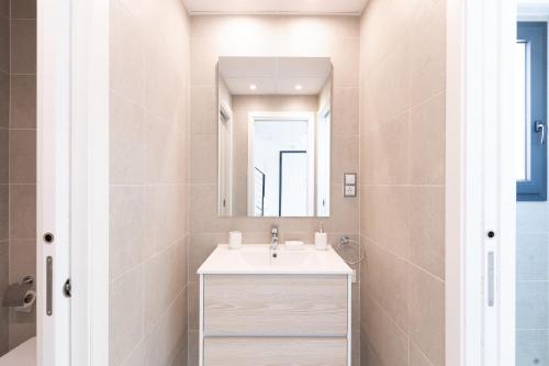 a bathroom with a sink and a mirror at Arenales Bahia Penthouse in Arenales del Sol