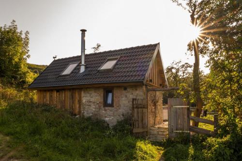 a small stone house with a black roof at Chalet Sternenzauber in Waasen