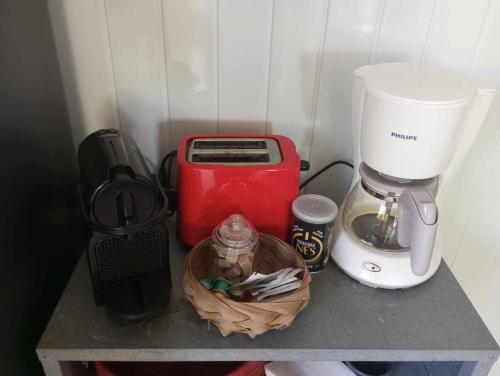 a kitchen counter with a coffee maker and a toaster at Les poinsettias in Les Trois-Îlets