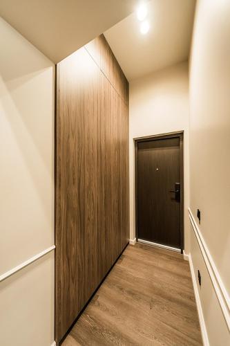 a hallway with a wooden door in a room at Central Park Apartments - The Luxury Collection in Kaunas