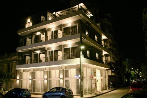 a building with cars parked in front of it at night at Piraeus Relax in Piraeus