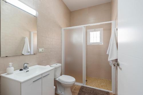 a bathroom with a toilet and a sink and a shower at Casa Rural Lola - Lantejuela in La Lantejuela