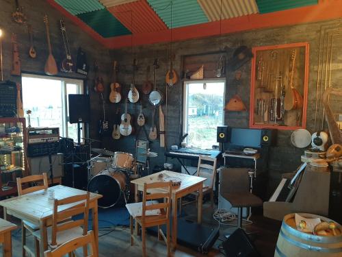 a kitchen with tables and chairs and pots and pans on the wall at Guesthouse Holmur in Hólmur