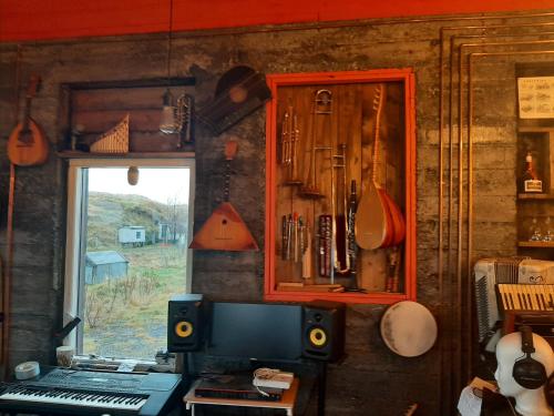 a room with a computer and a window and a cabinet at Guesthouse Holmur in Hólmur
