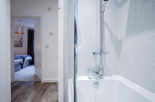 a bathroom with a shower and a bath tub at Luxurious Apartment Charlton Mews - 2 Bed - Tenby in Tenby