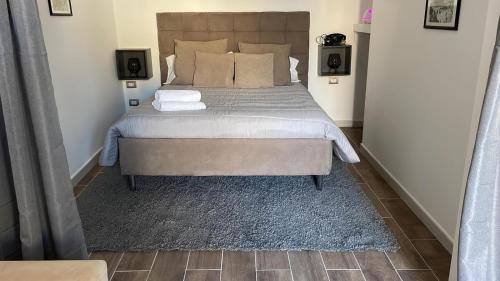 a bedroom with a large bed with two pillows at San Marco Apartment in Bari