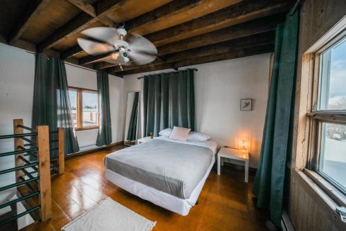 a bedroom with a bed and a ceiling fan at Les lofts Charlotte in Quebec City